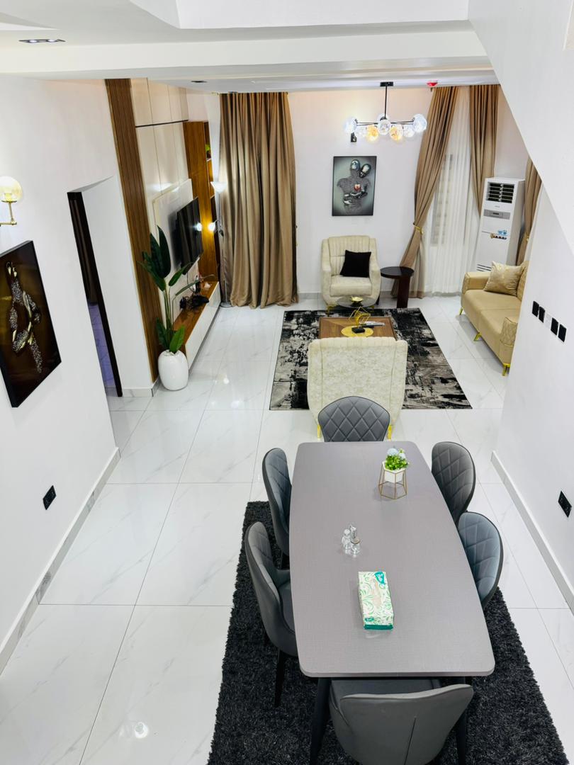 A dining table set for six beside the lounge