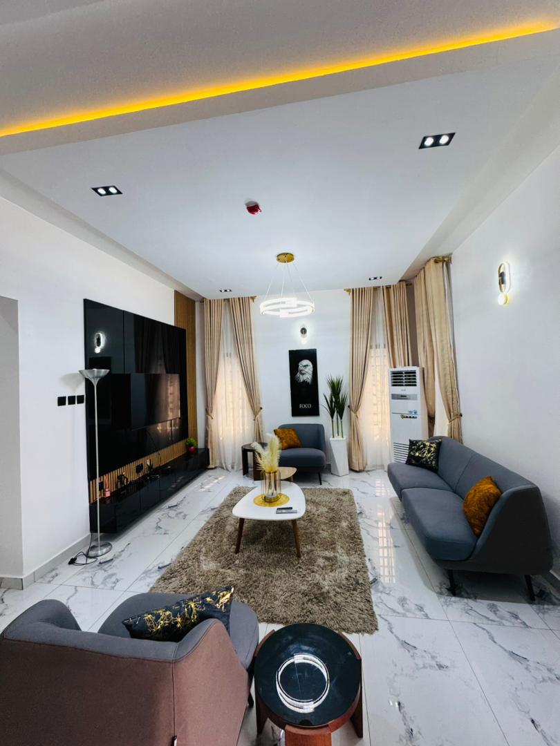 A living room with grey sofas and a patterned rug
